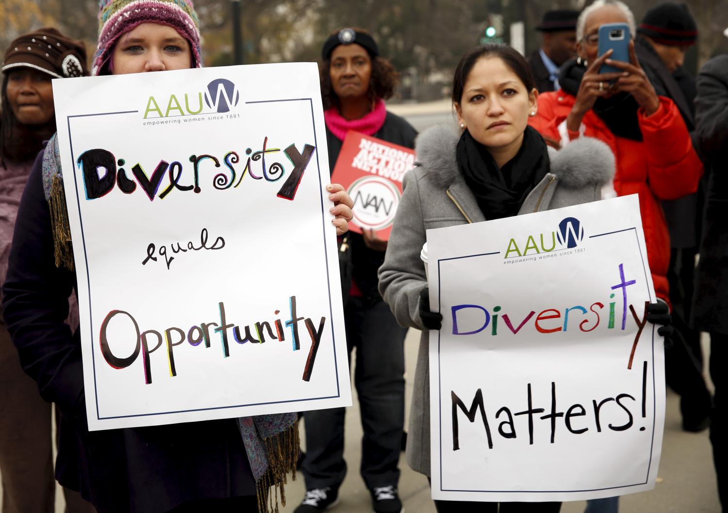 Demonstrators take part in a rally at the U.S. Supreme Court as the affirmative action in university admissions case was being heard at the court in Washington December 9, 2015. The Court was hearing arguments on Wednesday over race-based admissions at the University of Texas in a highly charged dispute that could reverberate nationwide. The justices revisited the case of Abigail Fisher, a 25-year-old white woman rejected for admission by the flagship campus in Austin in 2008. She argued that a University of Texas affirmative-action policy unconstitutionally favored blacks and Hispanics. REUTERS/Kevin Lamarque