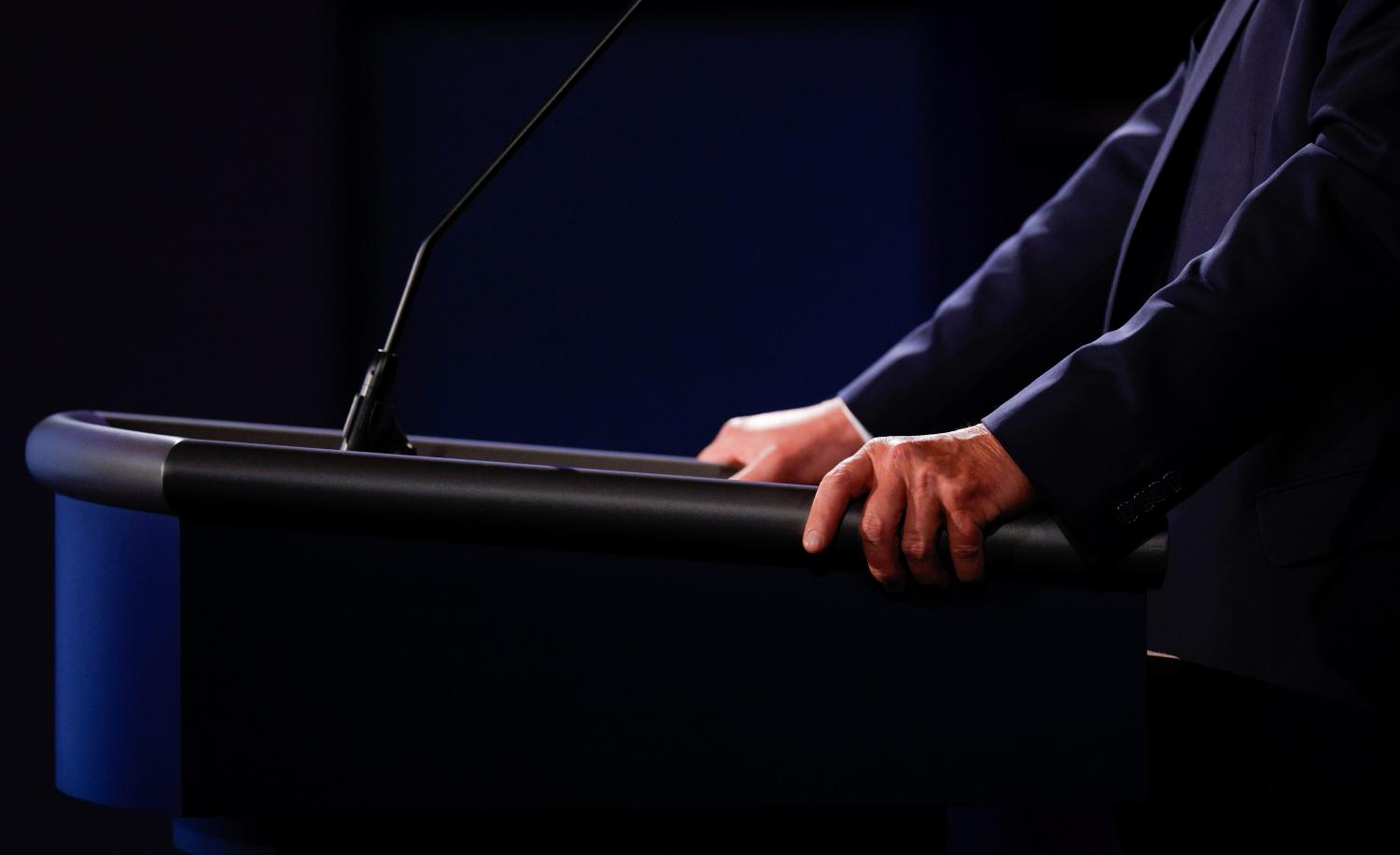 President Donald Trump grips his podium as he participates in the first 2020 presidential campaign debate with Democratic presidential nominee Joe Biden held on the campus of the Cleveland Clinic at Case Western Reserve University in Cleveland, Ohio, U.S., September 29, 2020. REUTERS/Brian Snyder