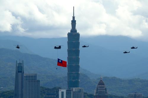 Military helicopters carrying tremendous Taiwan flags conduct a flyby rehearsal ahead of National Day celebration, near Taipei 101 , amid escalating tensions between Taipei and Beijing, China, in Taipei, Taiwan 7 October 2021. Taiwan has been constantly building fosters with the US, Japan, Australia, UK, and some other European countries such as Poland, Lithuania, Czech Republic, France and Germany, with China increasing military pressure on Taiwan.  (Photo by Ceng Shou Yi/NurPhoto)NO USE FRANCE