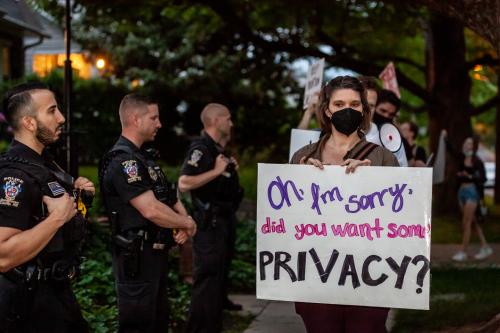 Pro-choice protestors march past police officers in front of Justice Brett Kavanaugh's house. (Photo by Allison Bailey/NurPhoto)