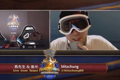 The esports player Blitzchung removes his mask during an online interview.