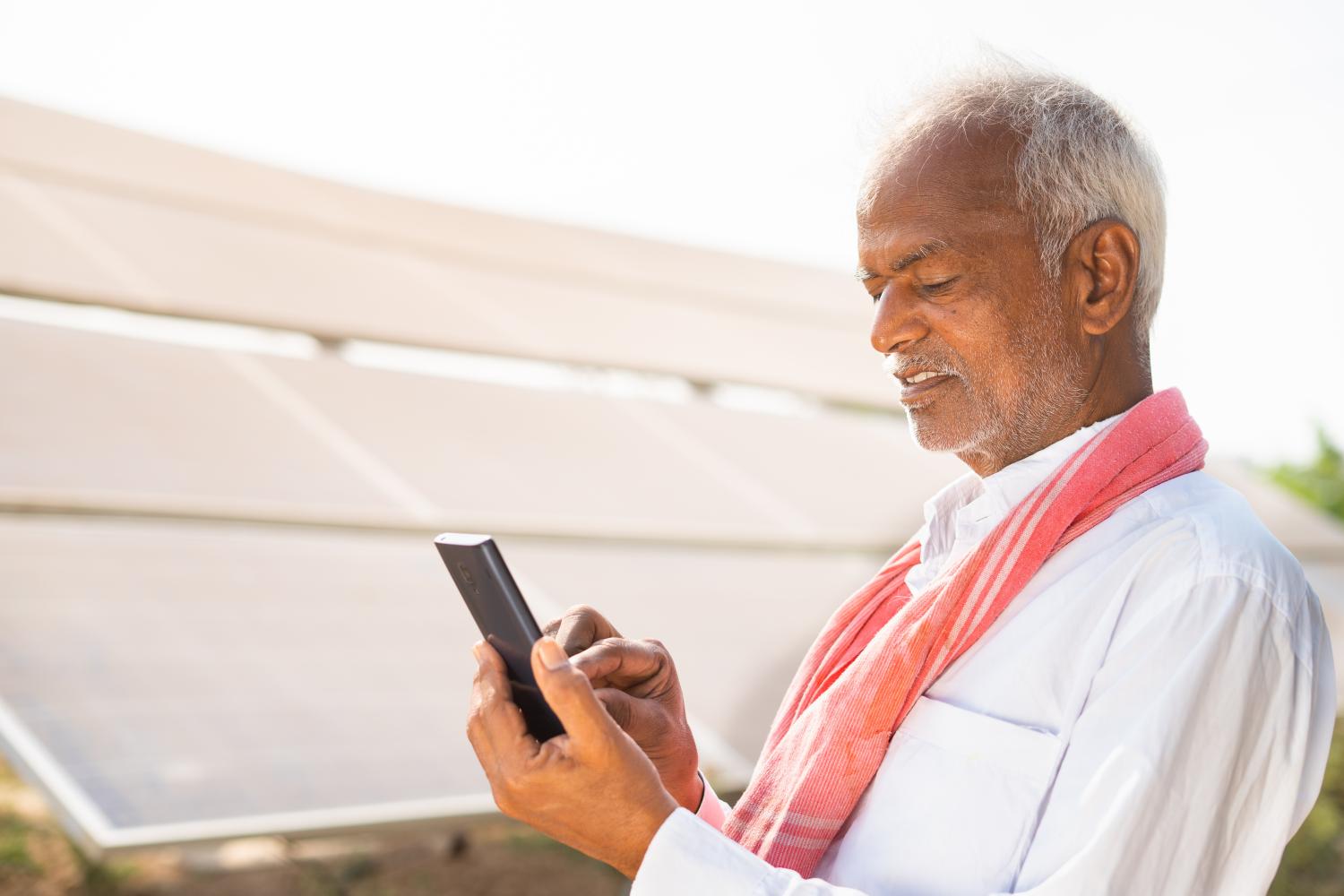 Indian,Farmer,Busy,Using,Mobile,Phone,In,Front,Of,Solar