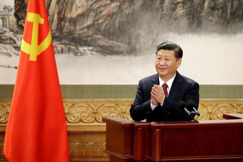 FILE PHOTO: Chinese President Xi Jinping claps after his speech as China's new Politburo Standing Committee members meet the press at the Great Hall of the People in Beijing, China October 25, 2017. REUTERS/Jason Lee/File Photo