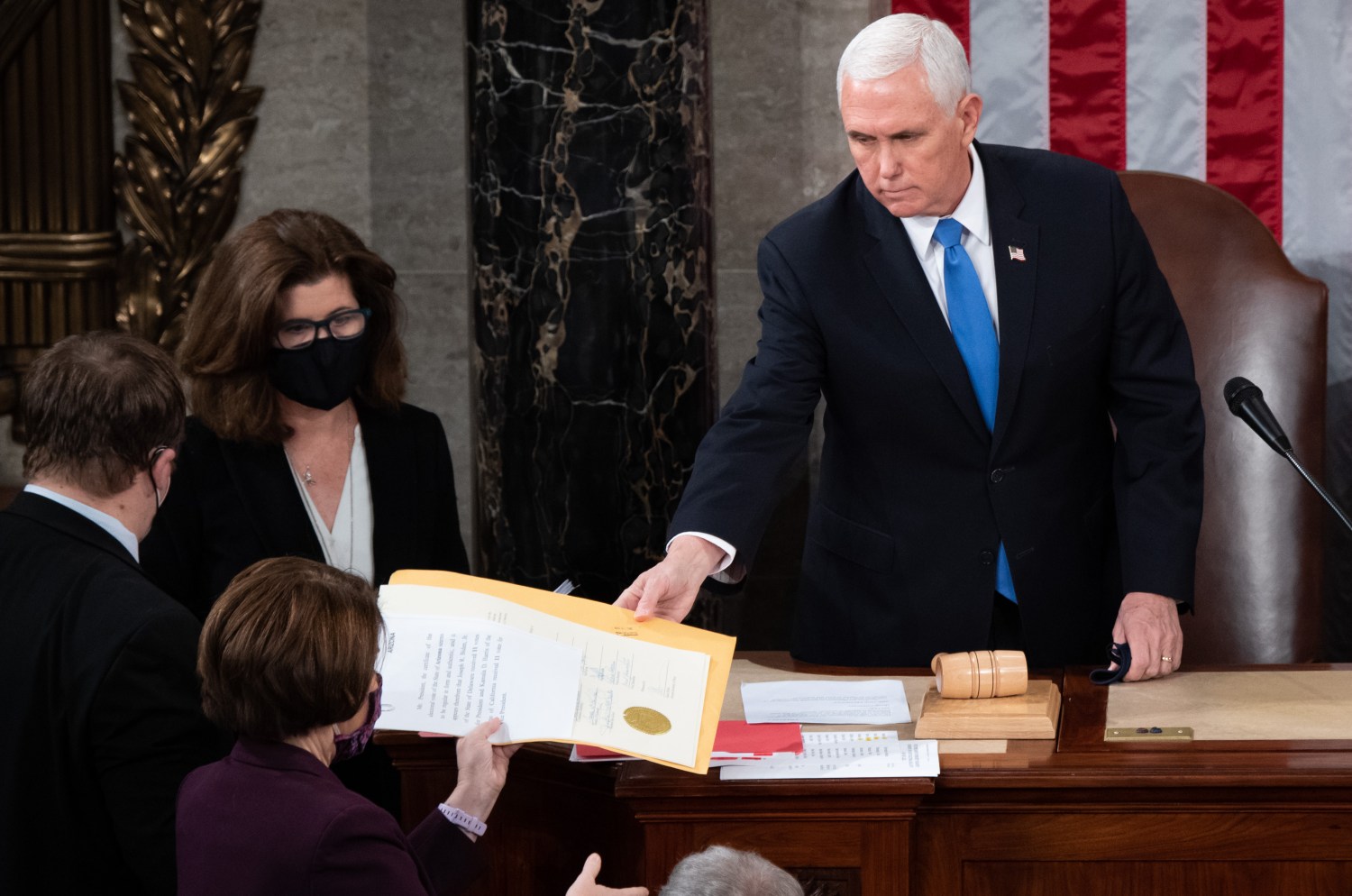 US Vice President Mike Pence hands the electoral certificate from the state of Arizona to US Senator Amy Klobuchar, Democrat of Minnesota, as he presides over a joint session of Congress to count the electoral votes for President at the US Capitol in Washington, DC, January 6, 2021. (Photo by Pool/Sipa USA)No Use UK. No Use Germany.