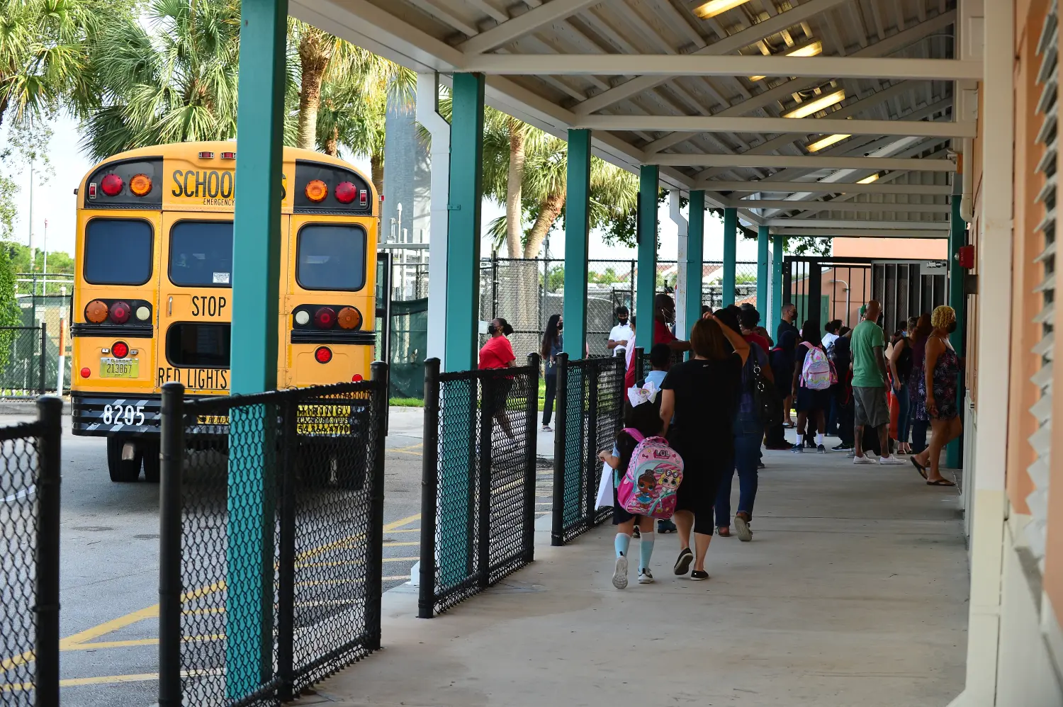 PEMBROKE PINES, FLORIDA - AUGUST 18: Student is seen drop off to school by they parents and school buses as faculty greet them arriving for the first day of classes at Broward Public County school in Pembroke Pines, Florida, U.S., on Wednesday, Aug. 18, 2021.  Florida State Board of Education said it would force defiant school districts to comply with Republican Governor Ron DeSantis executive order forbidding them from mandating students wear masks as a way to slow a surge in Covid-19 cases.   (Photo by JL/Sipa USA)No Use Germany.