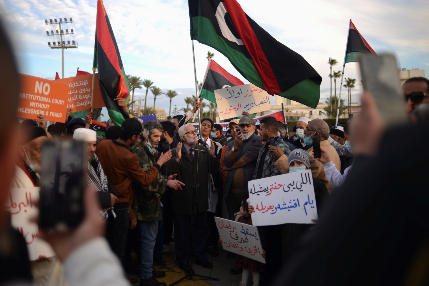 Libyans holding signs and their national flags participate in a protest against the parliament?s latest decision to name a new interim prime minister, at Martyr's square in Tripoli, Libya February 11, 2022. REUTERS/Nada Harib