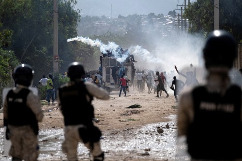 FILE PHOTO: Haitian National police officers deploy tear gas during a protest demanding the resignation of Haiti's Prime Minister Ariel Henry after weeks of shortages in Port-au-Prince, Haiti. Picture taken on October 17, 2022. REUTERS/Ricardo Arduengo/File Photo
