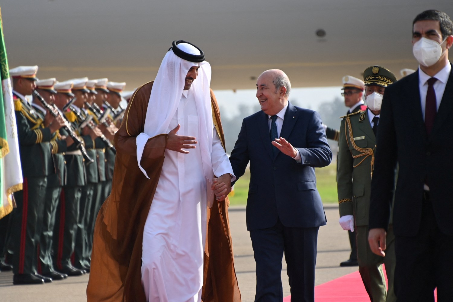 Algerian President Abelmadjid Tebboune welcomes Qatar's Emir Sheikh Tamim bin Hamad al-Thani upon his arrival in Algiers, to attend the Arab League summit, Algeria November 1, 2022. Algerian Presidency /Handout via REUTERS ATTENTION EDITORS - THIS IMAGE HAS BEEN SUPPLIED BY A THIRD PARTY.  NO RESALES. NO ARCHIVES.