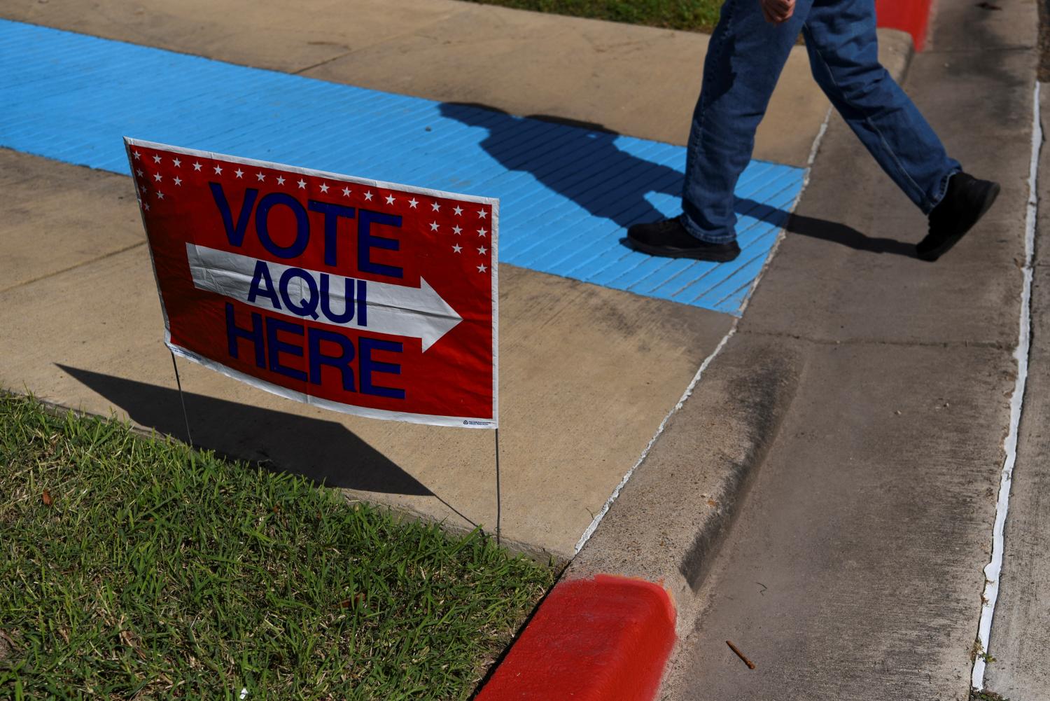 A voter walks past a sign during the 2022 midterm elections, in Harlingen, Texas, U.S., November 8, 2022.  REUTERS/Callaghan O'Hare