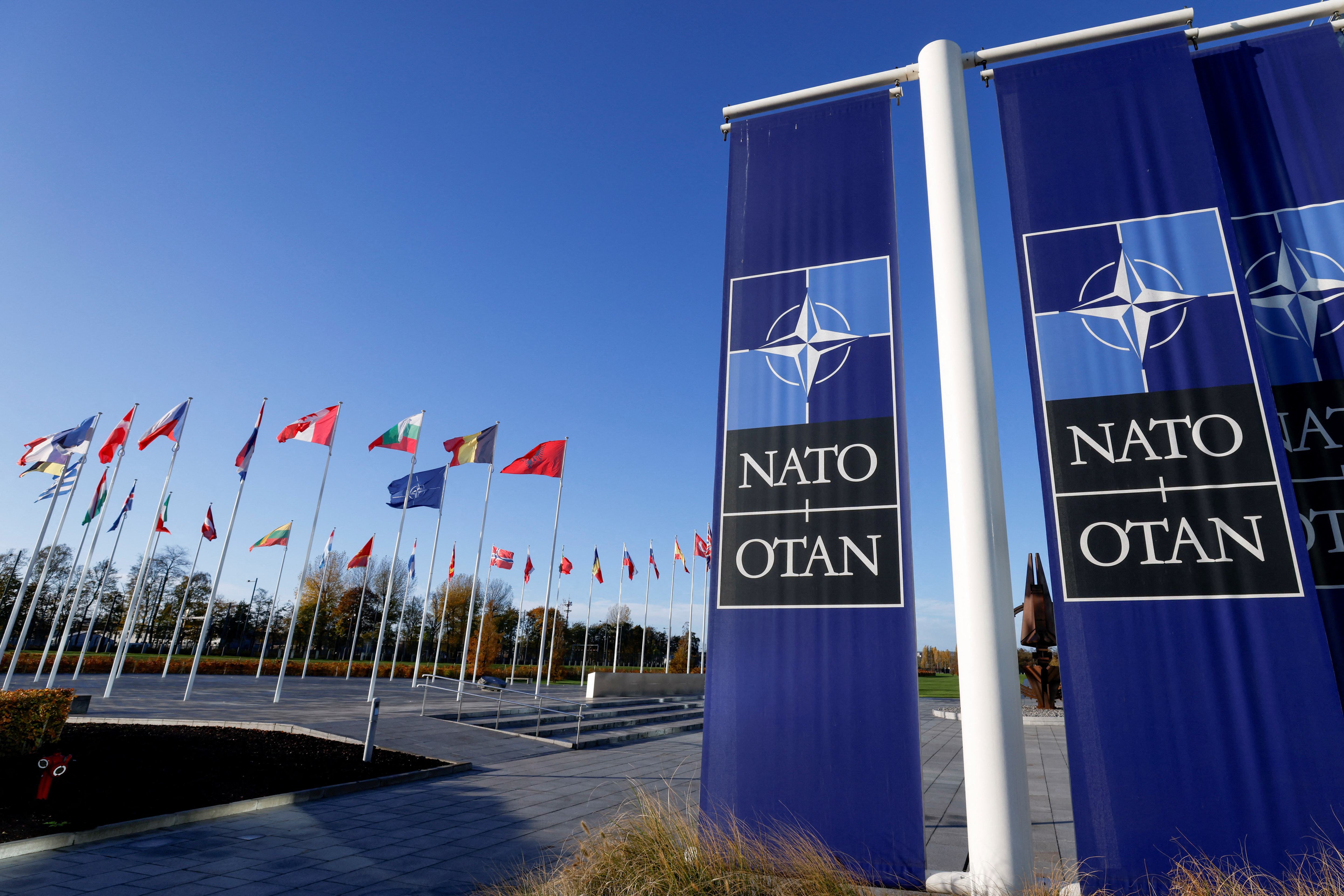 Flags fly outside NATO headquarters in Brussels, Belgium, November 16, 2022. REUTERS/Yves Herman