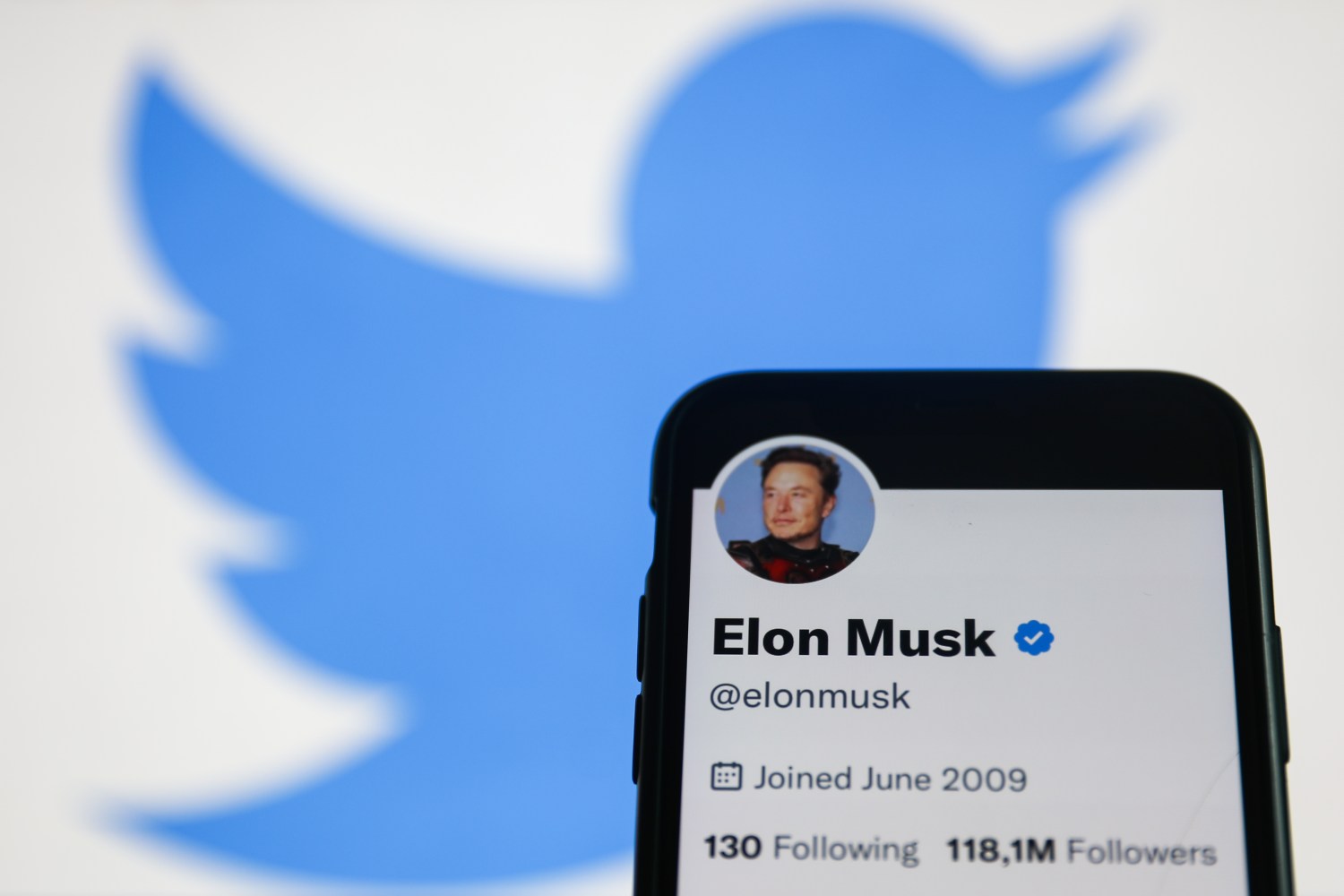 Elon Musk Twitter account displayed on a phone screen and Twitter logo displayed on a screen in the background are seen in this illustration photo taken in Krakow, Poland on November 22, 2022. (Photo by Jakub Porzycki/NurPhoto)NO USE FRANCE