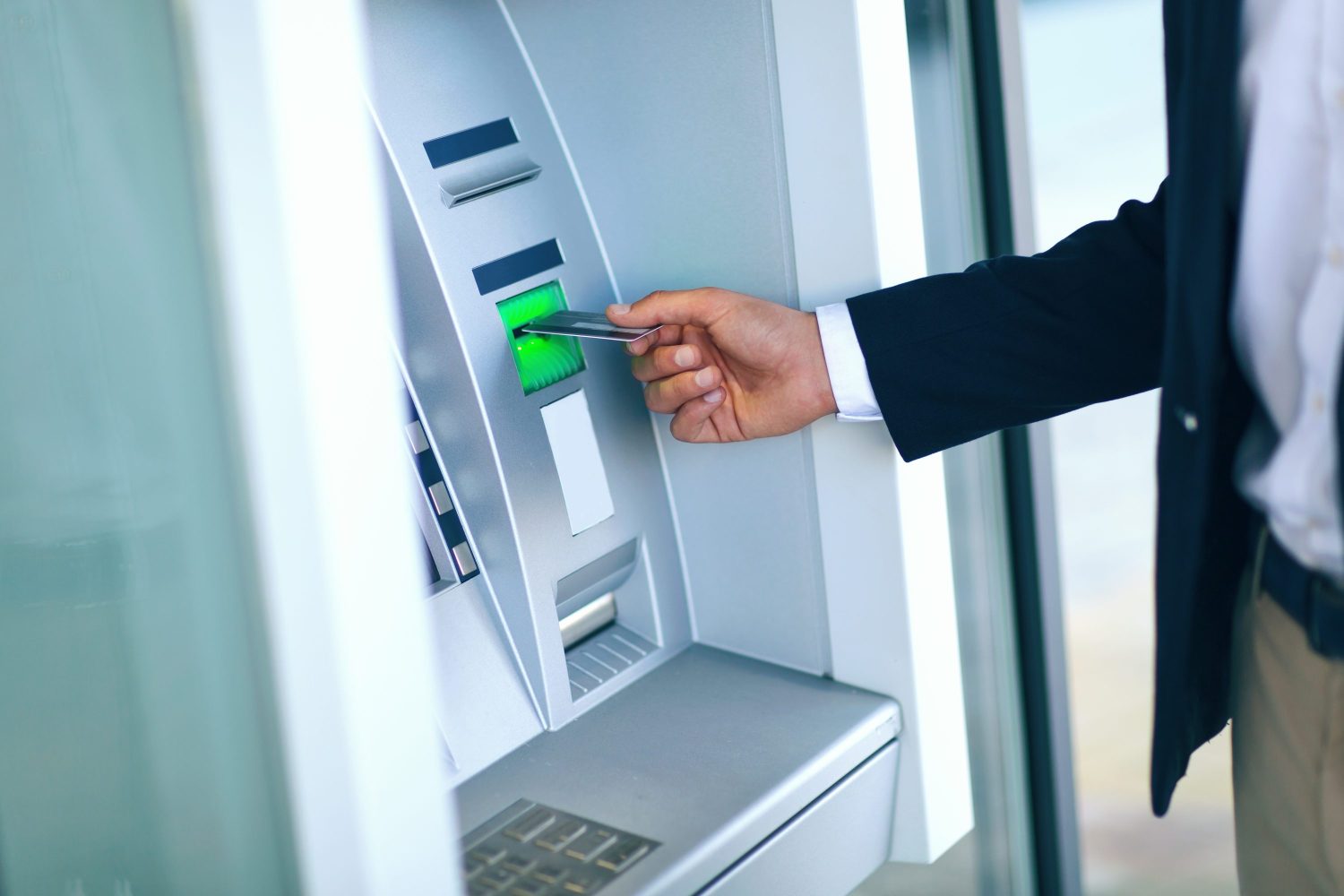 Person using an ATM machine.