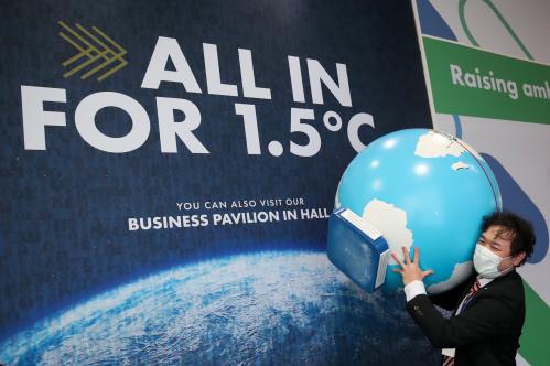 A person carries a globe model during the UN Climate Change Conference (COP26) in Glasgow, Scotland, Britain, November 8, 2021. REUTERS/Yves Herman