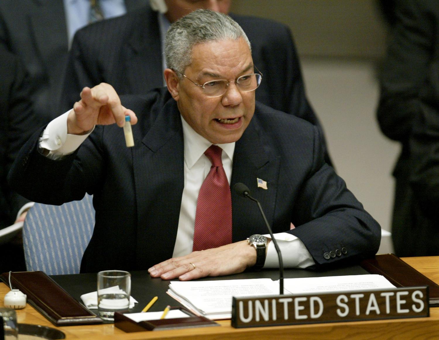 U.S. Secretary of State Colin Powell holds up a vial that he described as one that could contain anthrax, during his presentation on [Iraq] to the U.N. Security Council, in New York February 5, 2003. [Powell tried to persuade a sceptical world that Iraq is concealing it's weapons of mass destruction and that force may be necessary to disarm it.]