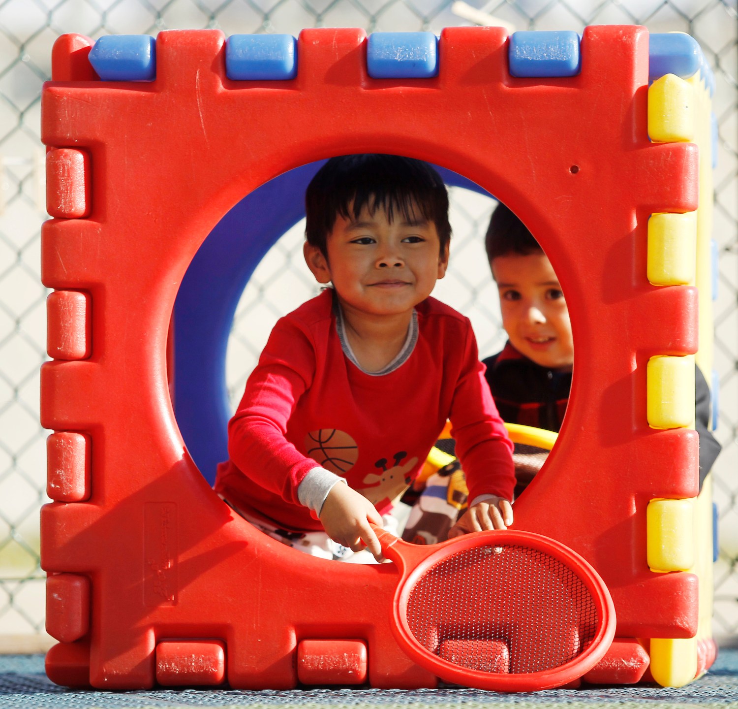 Four-year olds Ryan Htut (L) and Justin Hernandez play in a plastic cube at the Frederick, Maryland Head Start facility March 13, 2012. When officials in Frederick County, Maryland voted last year to stop paying for the local Head Start preschool program, they  pointed to a nearly $12 million projected budget shortfall as proof that the mostly rural county could no longer afford it. Picture taken March 13, 2012. To match story USA-EDUCATION/HEADSTART  REUTERS/Gary Cameron   (UNITED STATES - Tags: EDUCATION POLITICS)