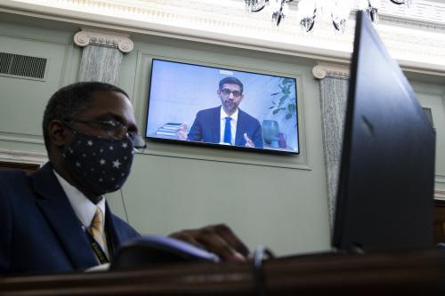 CEO of Alphabet Inc. and its subsidiary Google LLC, Sundar Pichai appears on a monitor behind a stenographer as he testifies remotely during the Senate Commerce, Science, and Transportation Committee hearing 'Does Section 230's Sweeping Immunity Enable Big Tech Bad Behavior?', on Capitol Hill in Washington, DC, USA, 28 October 2020. CEO of Twitter Jack Dorsey; CEO of Alphabet Inc. and its subsidiary Google LLC, Sundar Pichai; and CEO of Facebook Mark Zuckerberg all testified virtually at the hearing. Section 230 of the Communications Decency Act guarantees that tech companies can not be sued for content on their platforms, but the Justice Department has suggested limiting this legislation. Photo by MICHAEL REYNOLDS/Pool/ABACAPRESS.COM