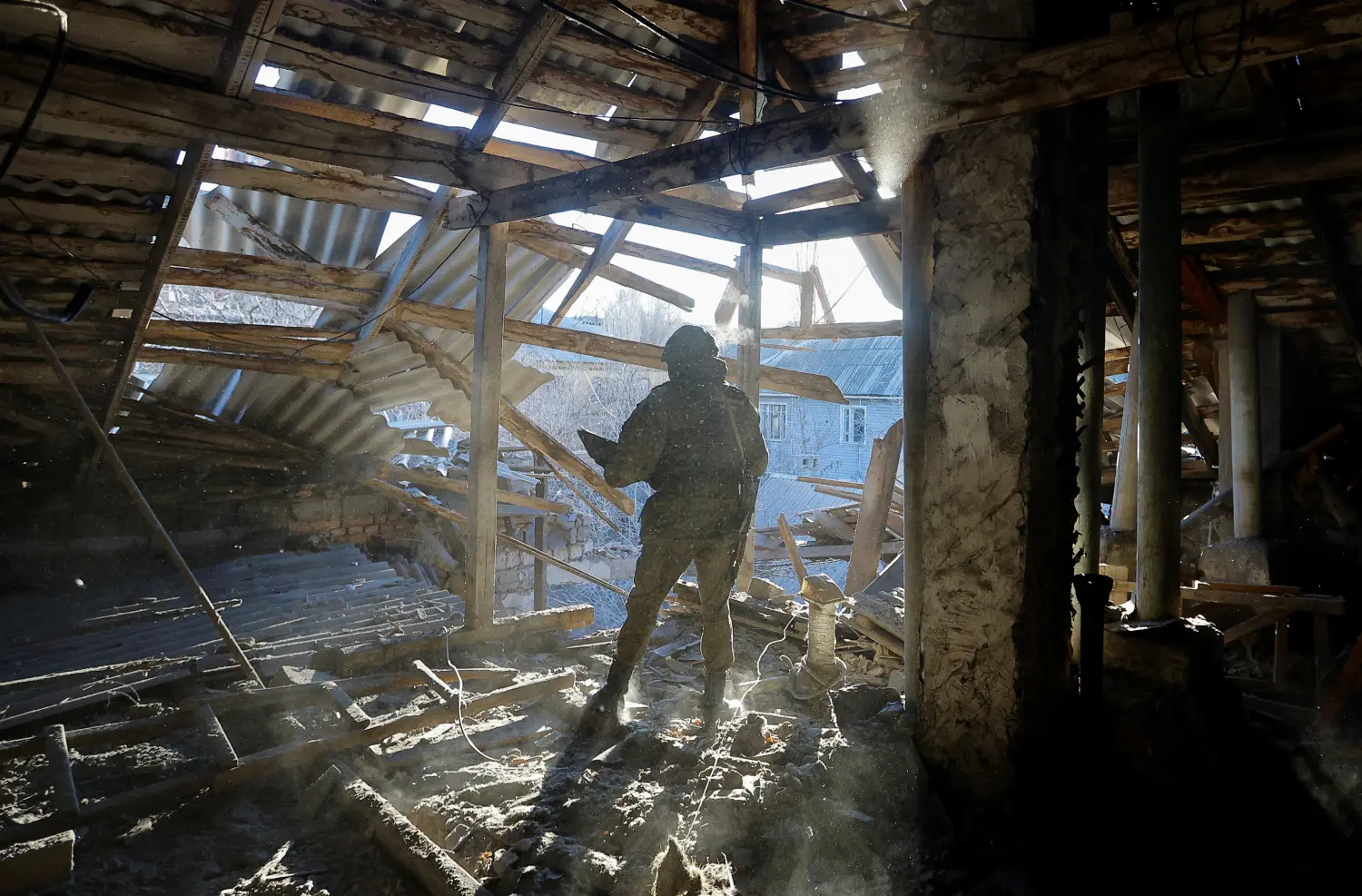 A Russian military investigator works inside a residential building heavily damaged in recent shelling in the course of Russia-Ukraine conflict in Donetsk, Russian-controlled Ukraine, December 6, 2022. REUTERS/Alexander Ermochenko