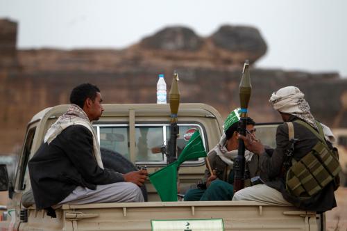 Armed followers of Yemen's Shi'ite Houthi group sit on a truck patrolling the vicinity of a ceremony attended by fellow Shi'ites in Dhahian of the northwestern Yemeni province of Saada February 3, 2012. A deadly assault by Shi'ite Houthi rebels on a Salafi Islamic school planted in their mountain heartland could ignite wider sectarian conflict in Yemen, where instability has already helped al Qaeda militants to take root. Picture taken February 3, 2012. To match Analysis YEMEN-STRIFE/ REUTERS/Khaled Abdullah (YEMEN - Tags: POLITICS CIVIL UNREST)