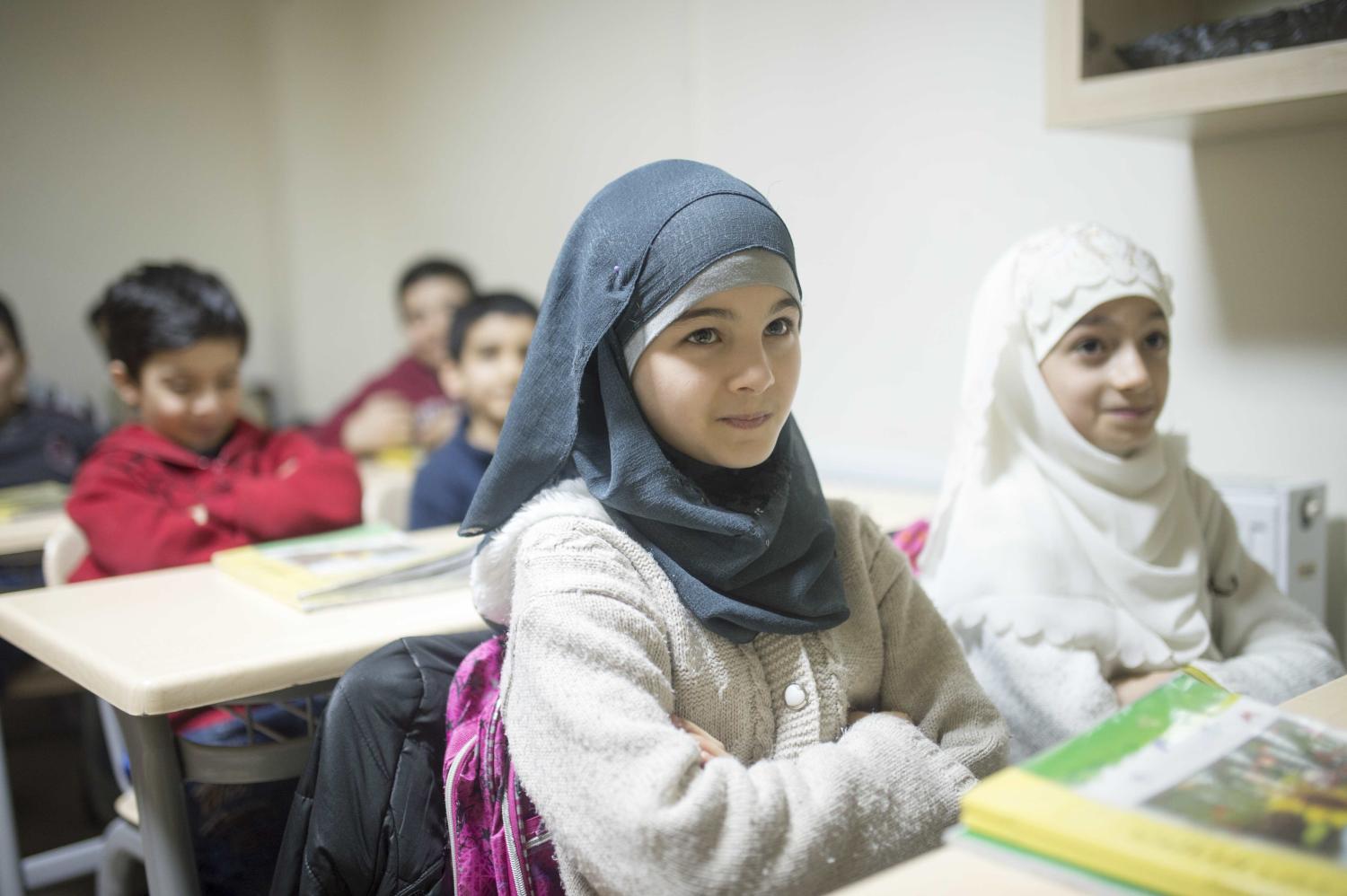 A refugee student learns in school.