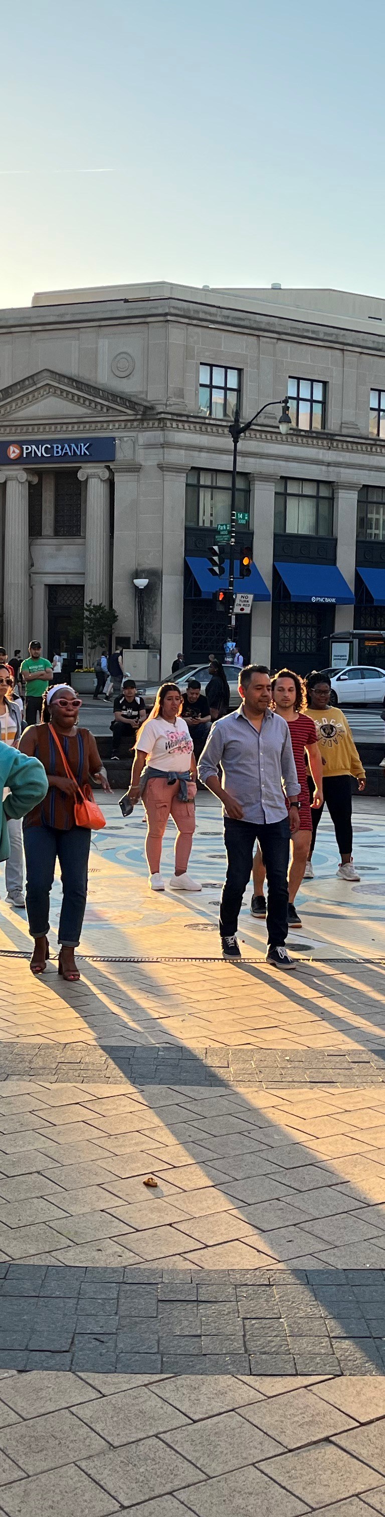 crowd of people walking through Washington D.C. plaza