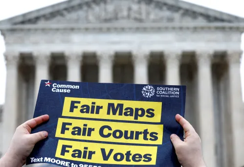 Demonstrators gather outside of the United States Supreme Court as the justices hear oral arguments in Moore v. Harper, a Republican-backed appeal to curb judicial oversight of elections, in Washington, U.S., December 7, 2022. REUTERS/Evelyn Hockstein