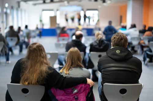 A student attends the enrollment of a fifth grade class at Alteburg School with her parents.