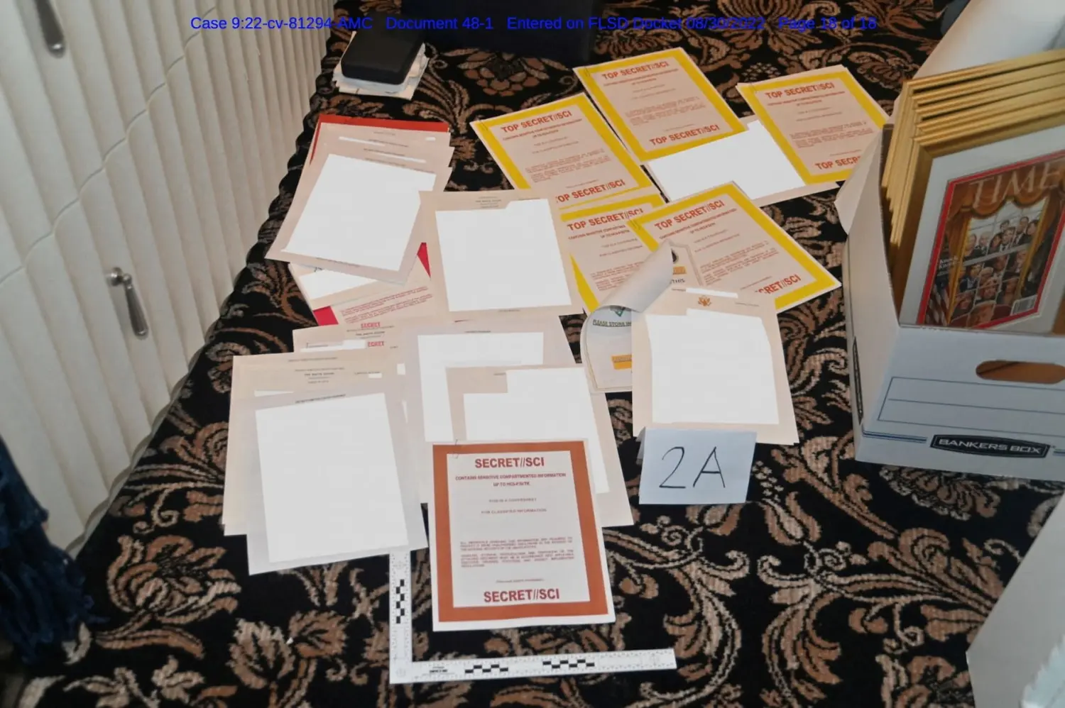 A redacted FBI photograph of documents and classified cover sheets recovered from a container stored in former U.S. president Donald Trump's Florida estate, and which was included in a U.S. Department of Justice filing and released August 30, 2022. U.S. Department of Justice/Handout via REUTERS