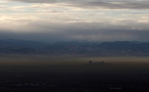 FILE PHOTO: The Rocky Mountains are pictured as a layer of air pollution hangs over Denver, Colorado, U.S. January 21, 2020. Picture taken January 21, 2020. REUTERS/Jim Urquhart/File Photo