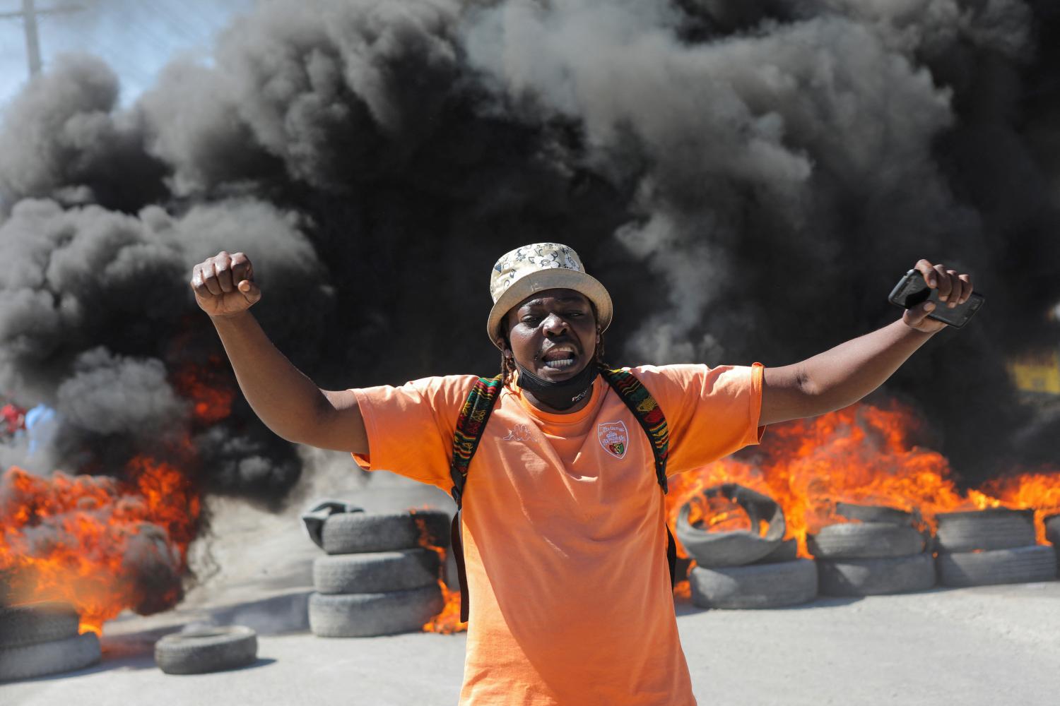 A demonstrator yells in front of a burning barricade during a protest for the recent killings of police officers by armed gangs, in Port-au-Prince, Haiti January 26, 2023. REUTERS/Ralph Tedy Erol