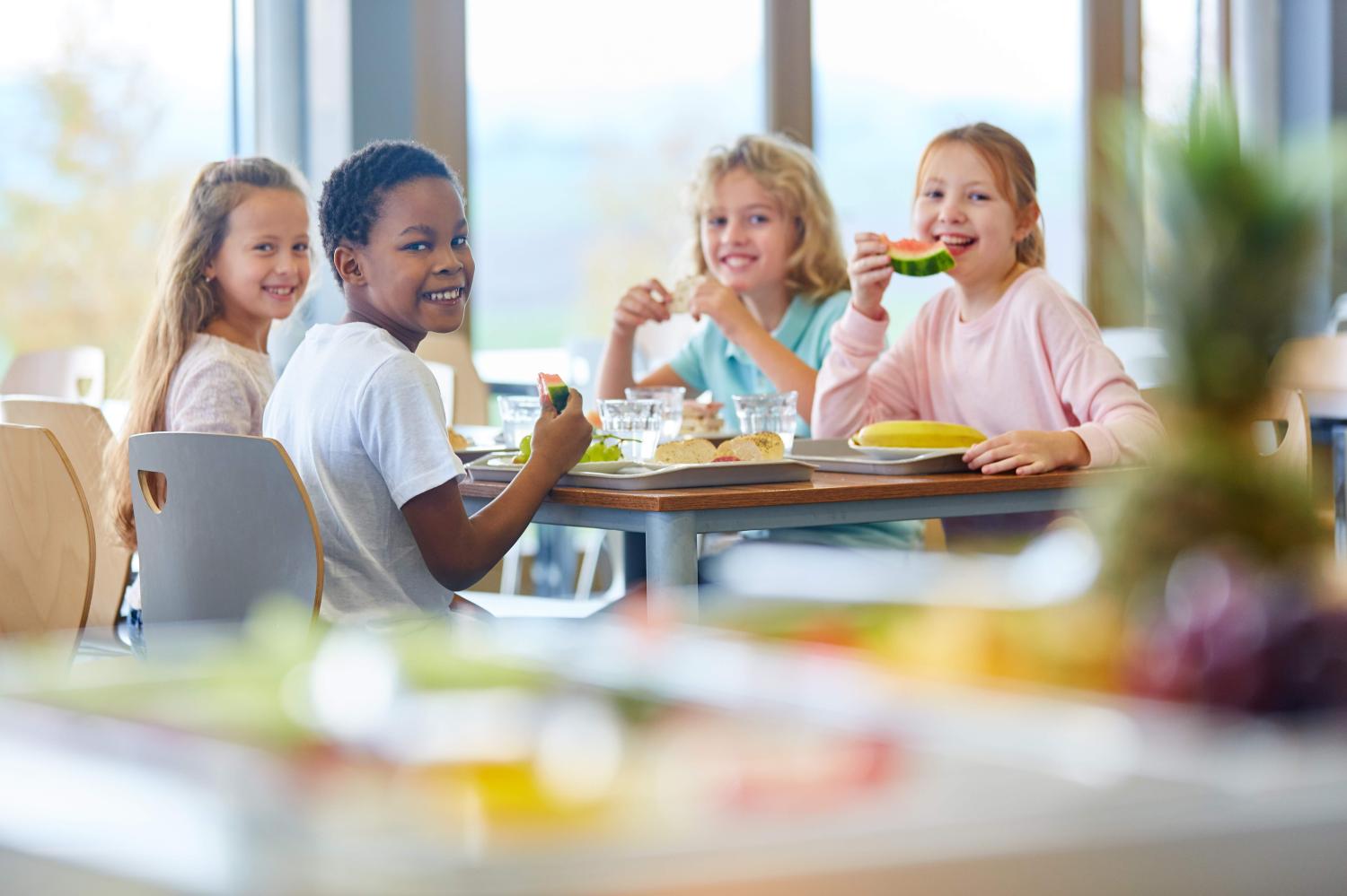 Children eat their lunch in the school cafeteria.