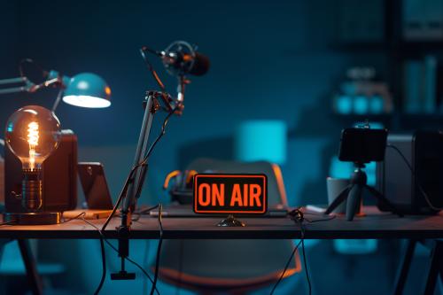 An on air sign illuminates a recording studio.