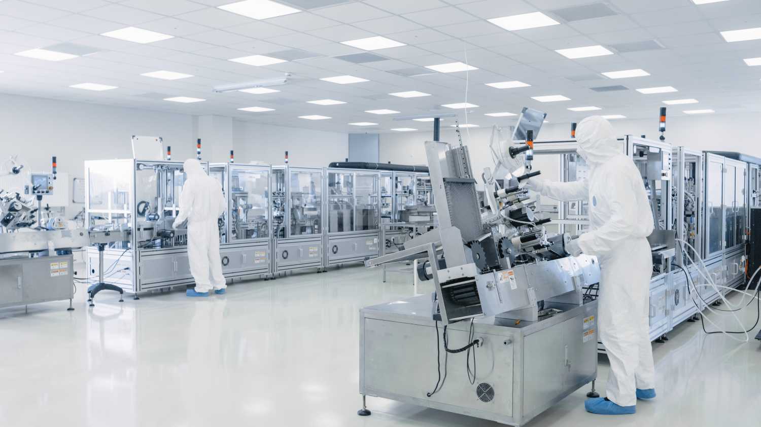 Sterile High Precision Manufacturing Laboratory where Scientists in Protective Coverall's Turn on Machninery, Use Computers and Microscopes, doing Pharmaceutics, Biotechnology Semiconductor Research.