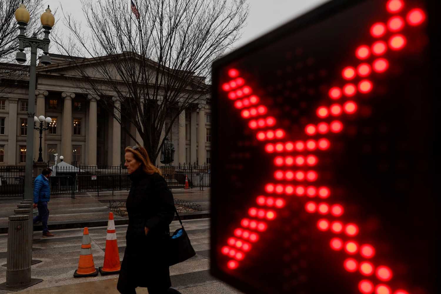 People walk past the U.S. Treasury building in Washington, U.S. January 19, 2023. REUTERS/Jonathan Ernst