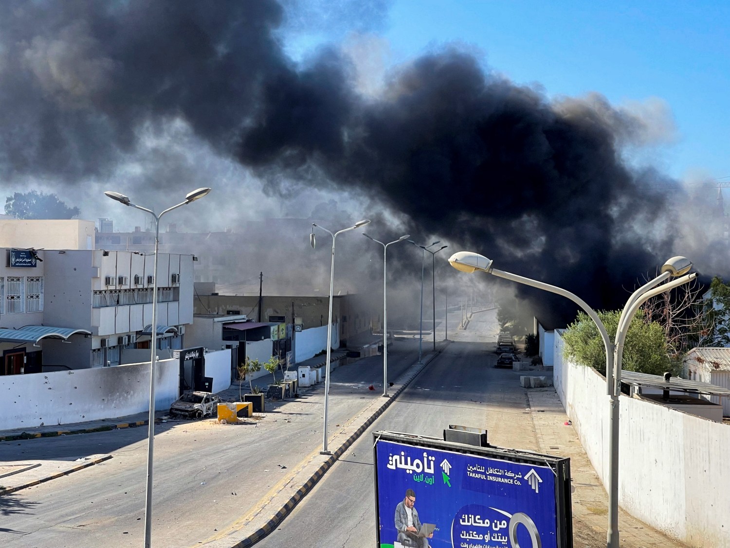 Smoke rises in the sky following clashes in Tripoli, Libya, August  27, 2022. REUTERS/Hazem Ahmed