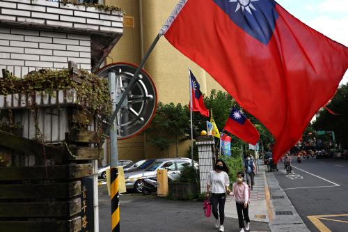 People walk by Taiwanese flags in Taipei, Taiwan, November 14, 2022. REUTERS/Ann Wang