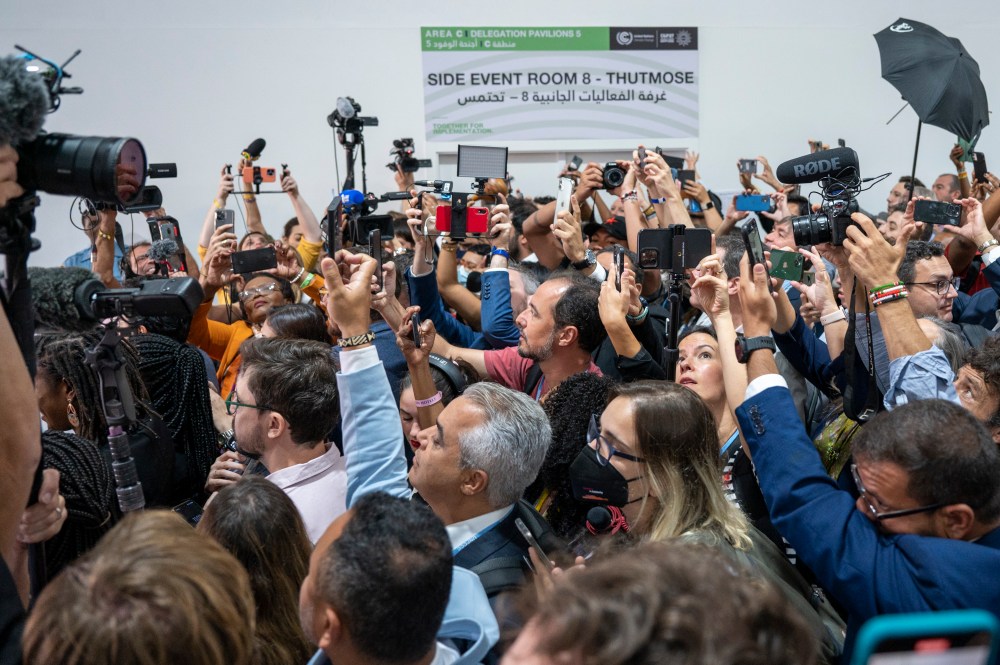 Participants and journalists take photos and videos during the arrival of the new Brazilian President Lula da Silva at the UN Climate Summit COP27.