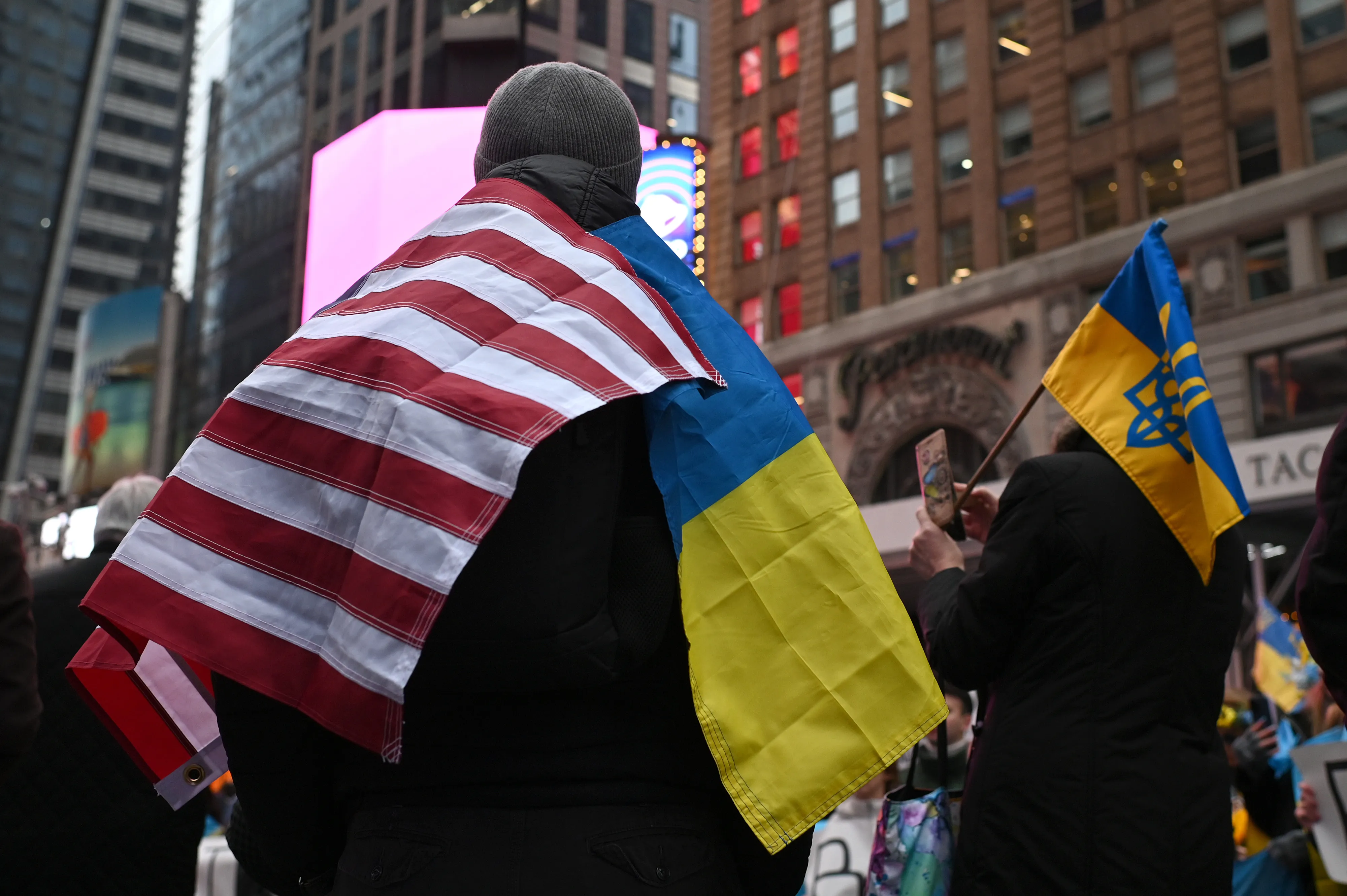 A man wearing both a US flag and a Ukrainian flag attends a rally in Times Square to protest the ongoing war in Ukraine nearly a year after Russias invasion, New York, NY, January 22, 2023. (Photo by Anthony Behar/Sipa USA)No Use Germany.