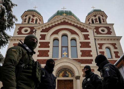 FILE PHOTO: Ukrainian law enforcement officers stand next to St. George's Cathedral of the Ukrainian Orthodox Church branch loyal to Moscow, in Lviv, Ukraine, December 14, 2022.  REUTERS/Roman Baluk/File Photo