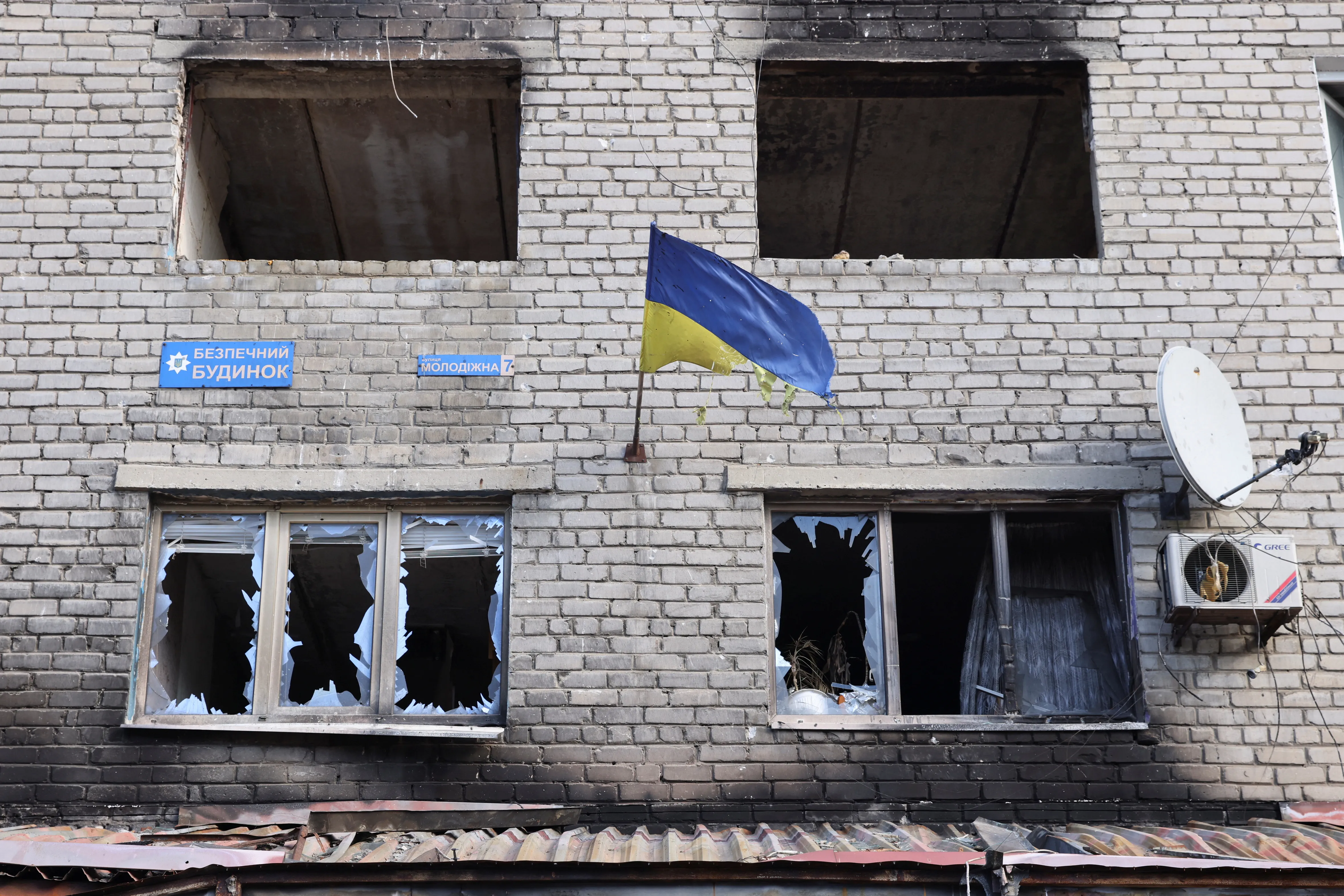 A ragged Ukrainian national flag is seen on a damaged building in the town of Siversk, amid Russia's attack on Ukraine, in Donetsk region, Ukraine February 20, 2023. REUTERS/Yevhen Titov