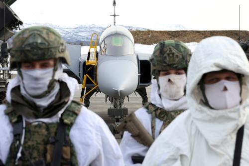 Dutch Marines stand in front of a jet, during the visit of NATO Secretary General Jens Stoltenberg at a base, as part of a military exercise called "Cold Response 2022", gathering around 30,000 troops from NATO member countries plus Finland and Sweden, amid Russia's invasion of Ukraine, in Bardufoss in the Arctic Circle, Norway, March 25, 2022. REUTERS/Yves Herman