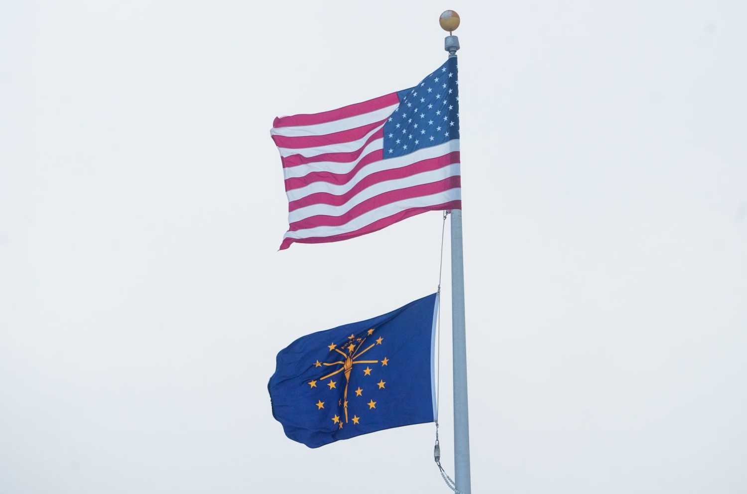 An American and State of Indiana flag fly Friday, Dec. 23, 2022, during a frigidly cold day in Central Indiana.
