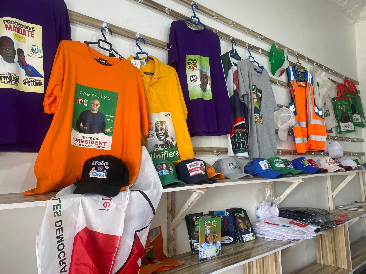 Branded T-shirts, baseball caps and notebooks with images of Nigerian presidential candidates are displayed at a shopping center in Abuja, Nigeria February 2, 2023. REUTERS/Abraham Achirga