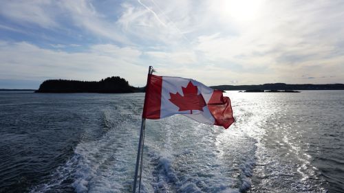 Canadian flag against a lake
