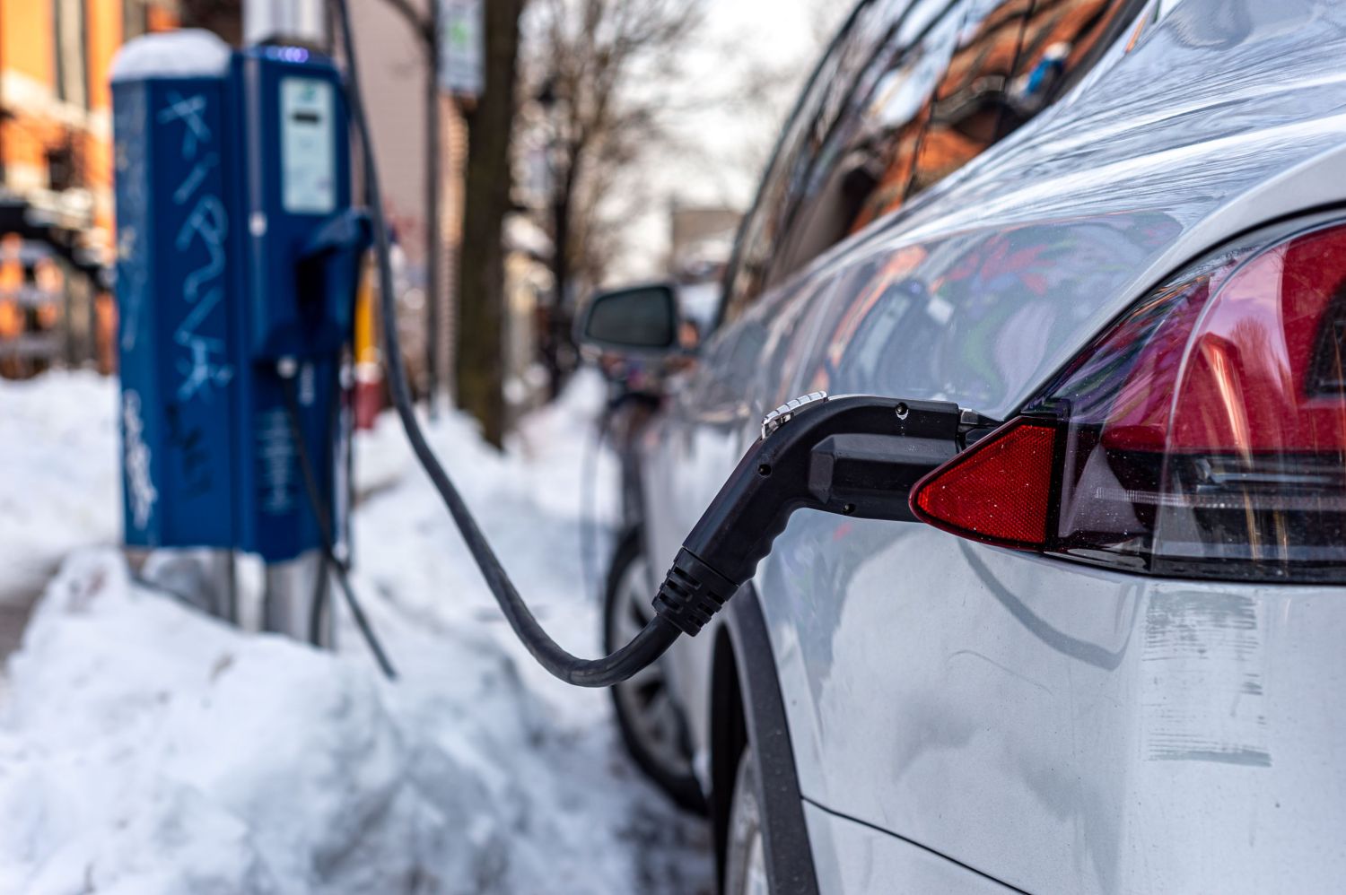 Electric car getting charged in Montreal during the winter season