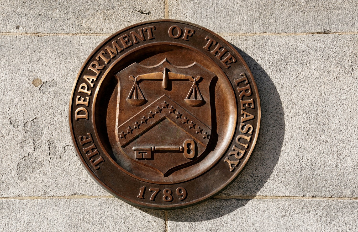 FILE PHOTO: A bronze seal for the Department of the Treasury is shown at the U.S. Treasury building in Washington, U.S., January 20, 2023.  REUTERS/Kevin Lamarque/File Photo/File Photo