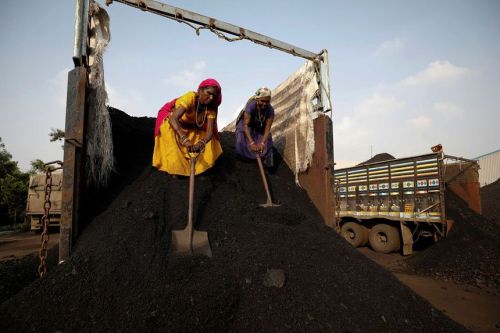 Workers unload coal