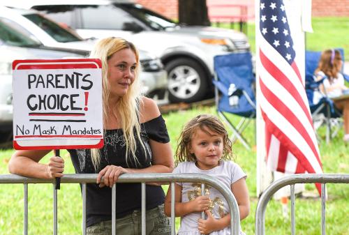 A woman holds a placard outside a meeting of the Volusia County School Board in Deland. The school board voted 3-2 to modify the mandatory school mask requirement to allow parents to opt out of the requirement for their children. (Photo by Paul Hennessy / SOPA Images/Sipa USA)No Use Germany.
