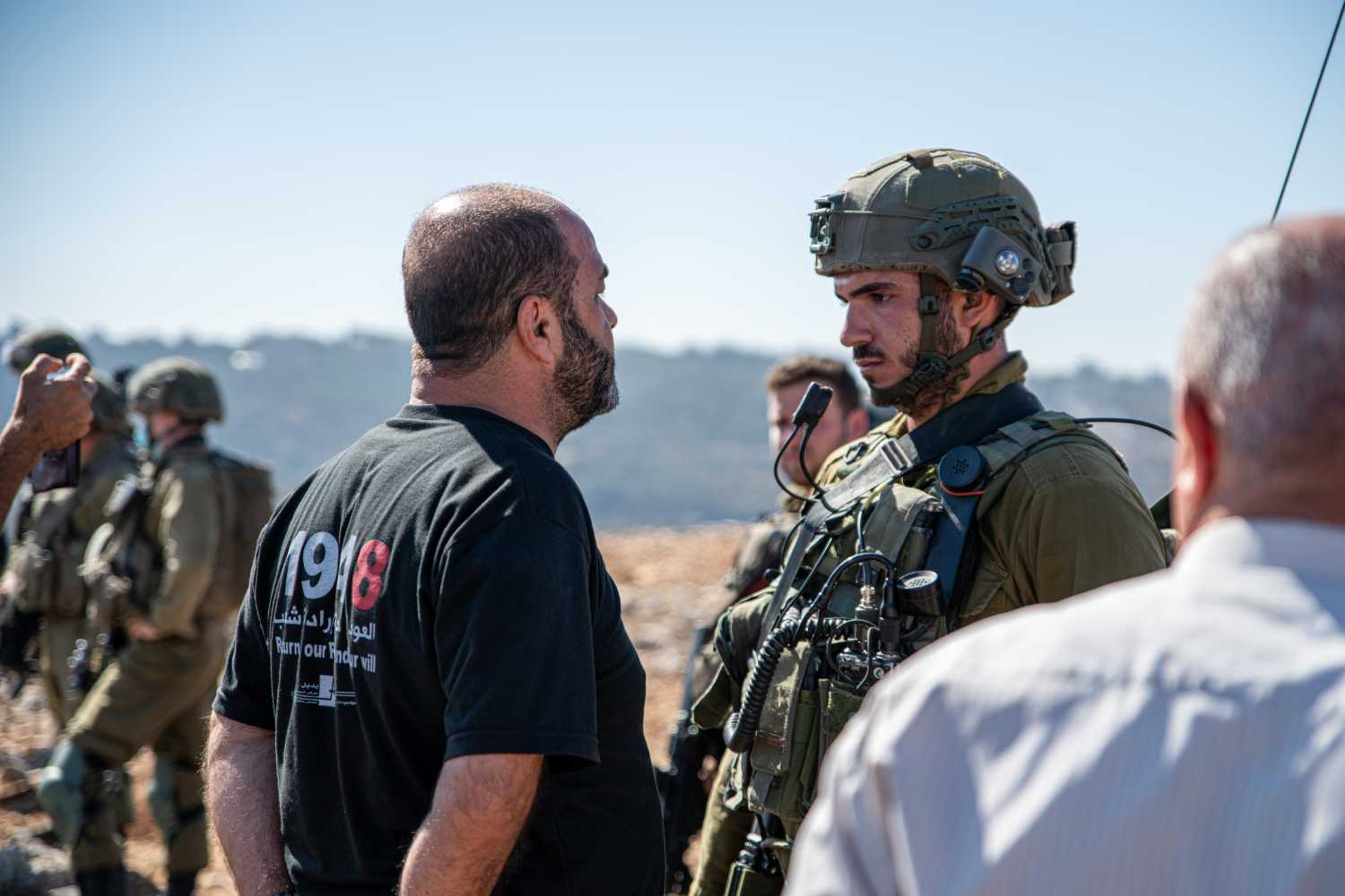 Israel Defence Forces soldiers preventing access for locals and activists from olive plantations during harvest season in Salfit, The West Bank on Oct. 11, 2021. The plantation on the outskirts of the town of Salfit was annexed in the last year to a new Jewish outpost - Avi view farm, although Plestinians hold land deeds for the land. During an attempt to break the white line zoning a closed military zone in the plantations, the army used stun grenades and arrested three activists. (Photo by Matan Golan/Sipa USA)No Use Germany.