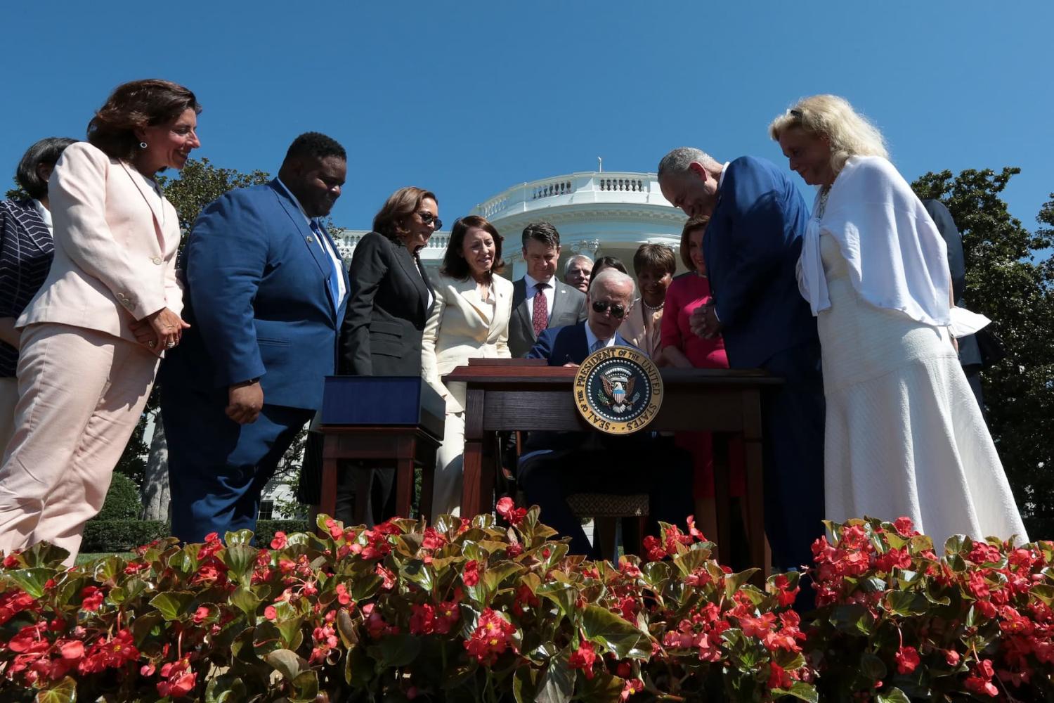President Joe Biden, center, signs into law H.R. 4346, the CHIPS and Science Act of 2022 on the South Lawn of the White House on Aug. 9, 2022 in Washington, DC. (Photo by Oliver Contreras/Sipa USA)