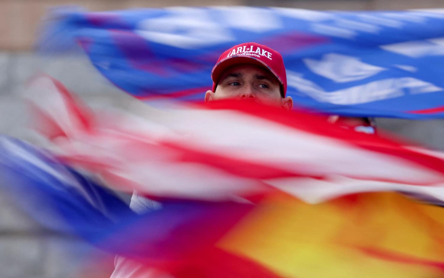 A supporter of defeated Republican candidate for Arizona Governor Kari Lake, Republican candidate for Arizona Secretary of State Mark Finchem and Republican U.S. Senate candidate Blake Masters protests outside the Arizona State Capitol, in Phoenix, Arizona, U.S., November 15, 2022. REUTERS/Jim Urquhart TPX IMAGES OF THE DAY